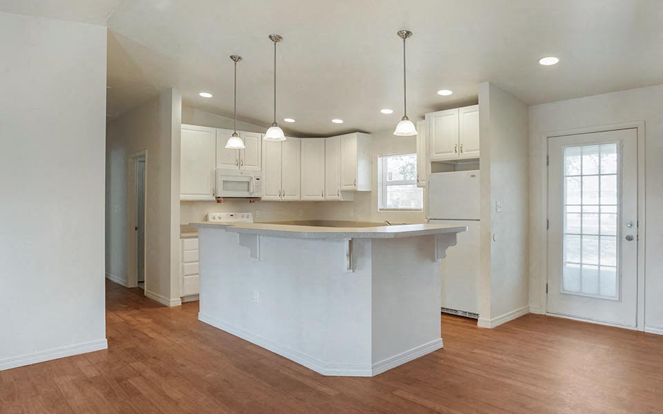 an empty kitchen with an island in the middle