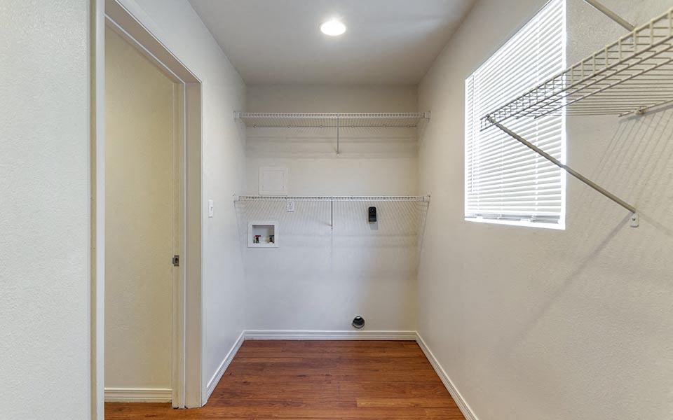 an empty room with a closet and a window