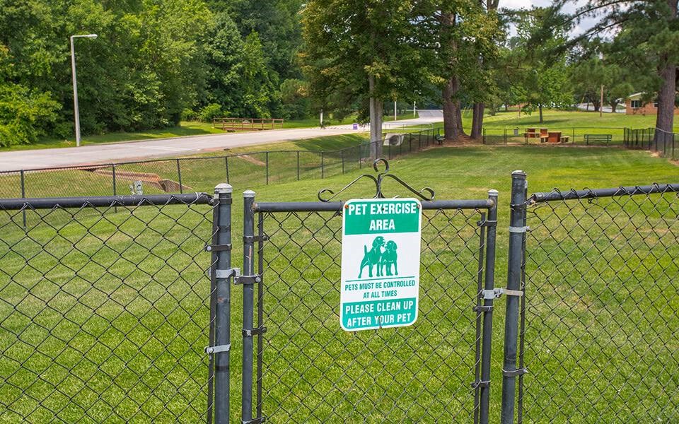 a fence with a sign that says pet guardians area