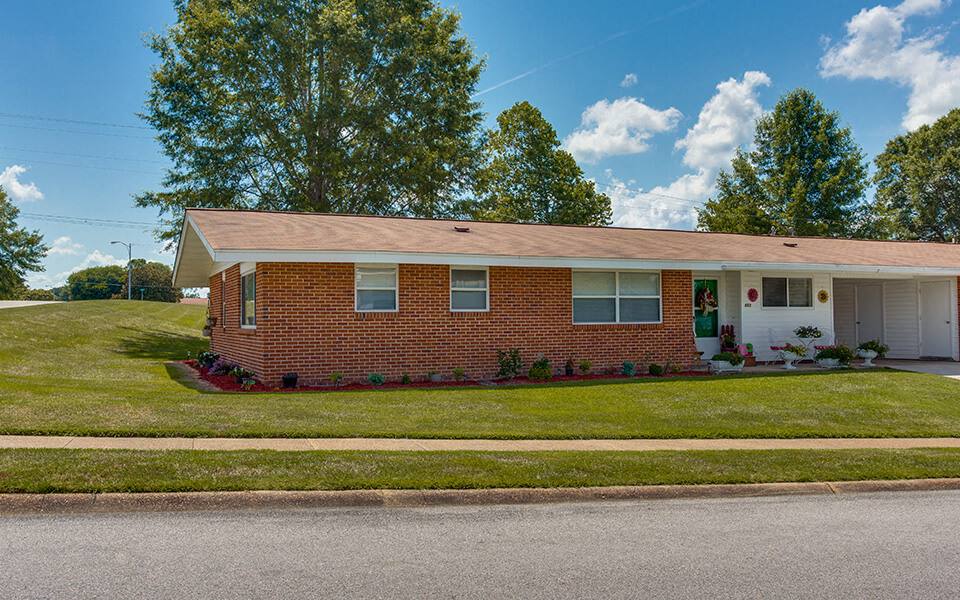 a brick house on the side of a street