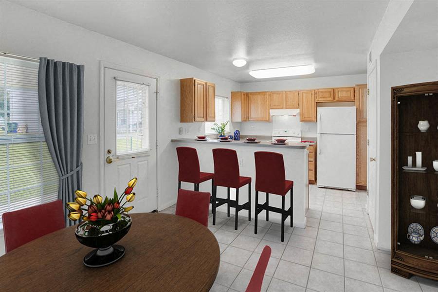 a kitchen and dining room with a table and chairs