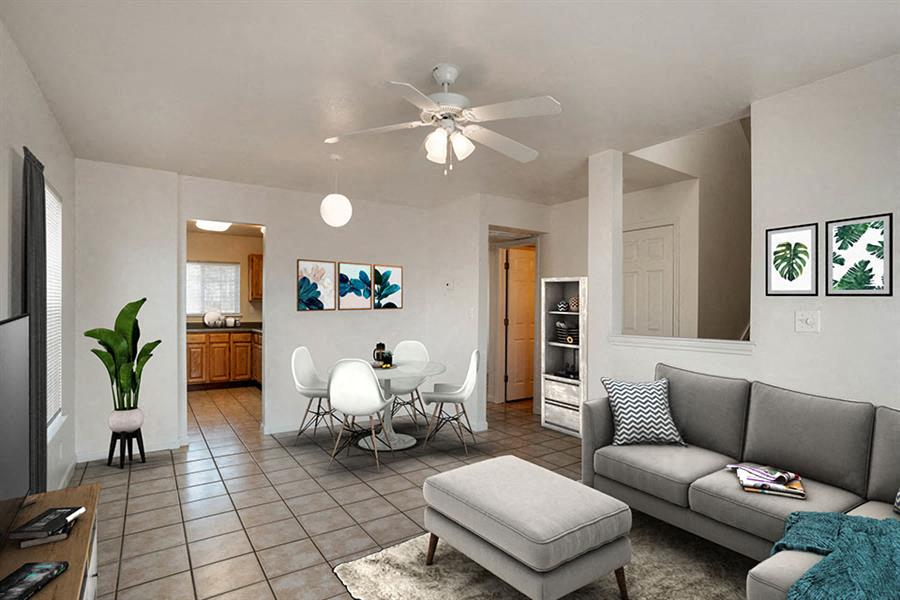a living room with a couch and a dining table