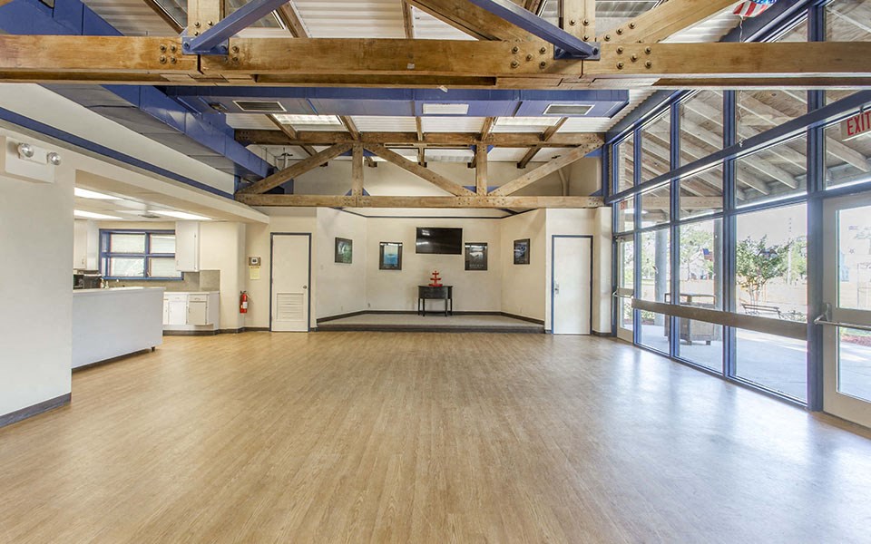 a large room with a wood floor and glass doors