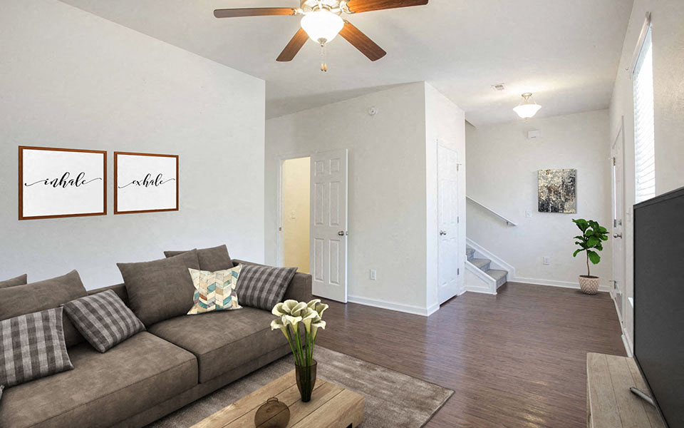 a living room with a couch and a ceiling fan