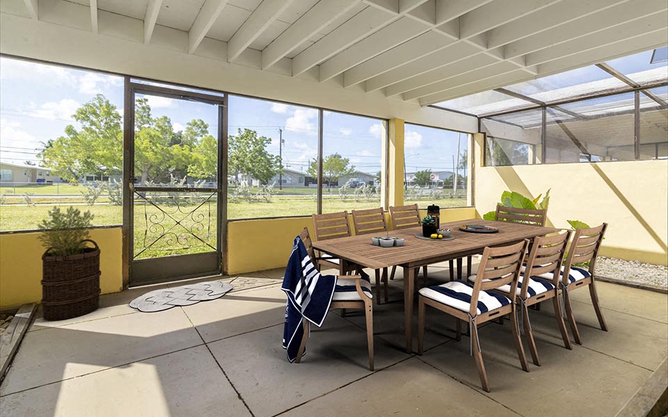 a dining area with a table and chairs on a patio