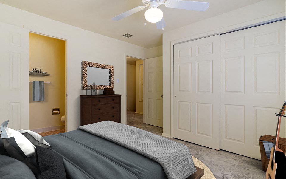 a bedroom with a bed and a ceiling fan