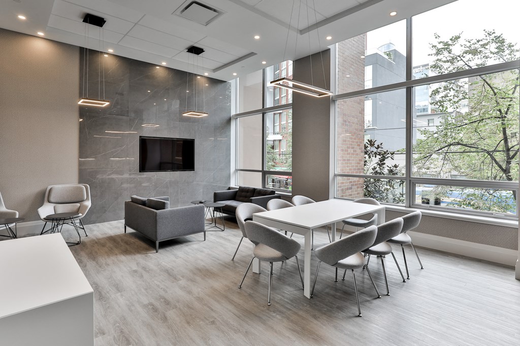 a conference room with tables and chairs and a large window