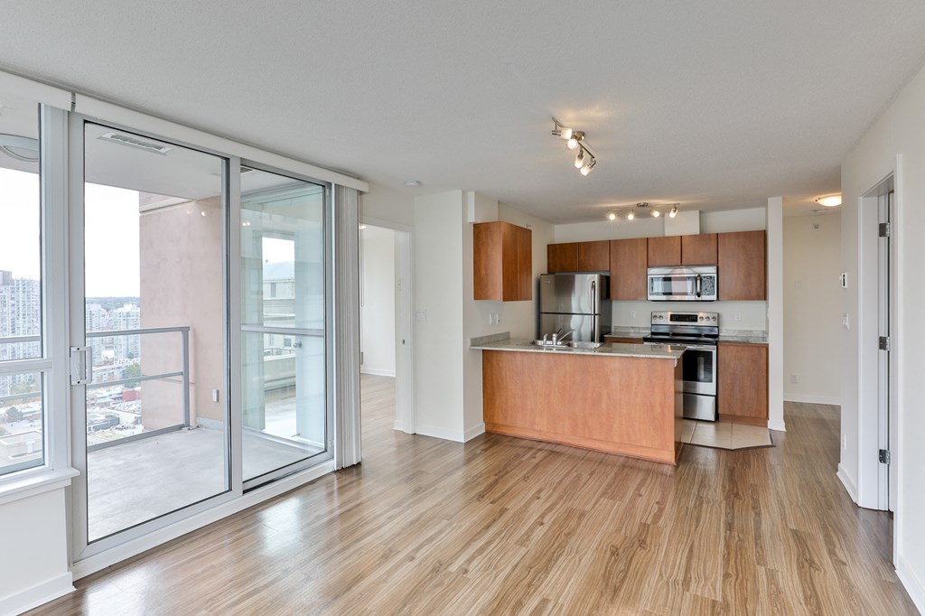 a kitchen with wood flooring and a sliding glass door