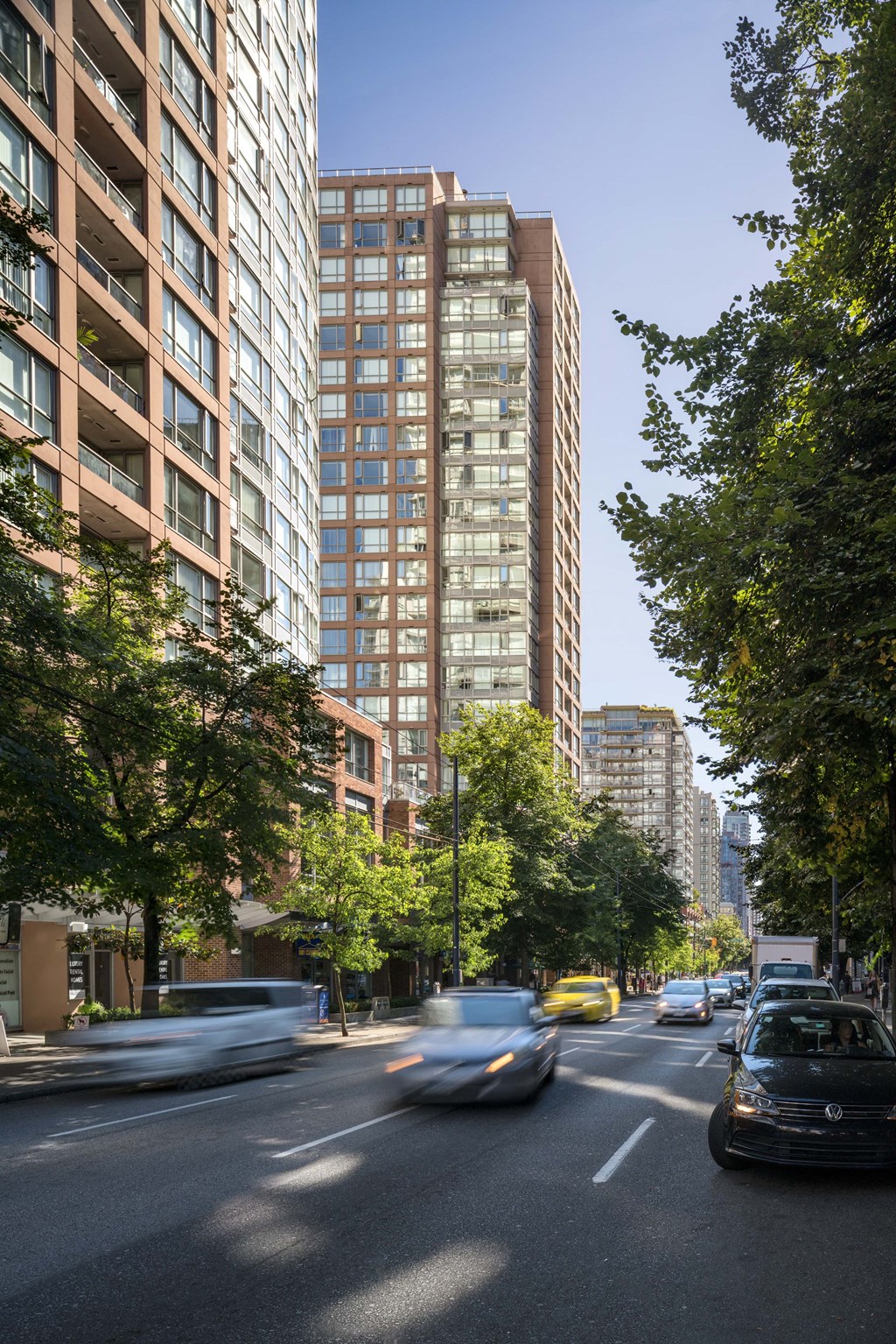 a busy city street with cars and tall buildings