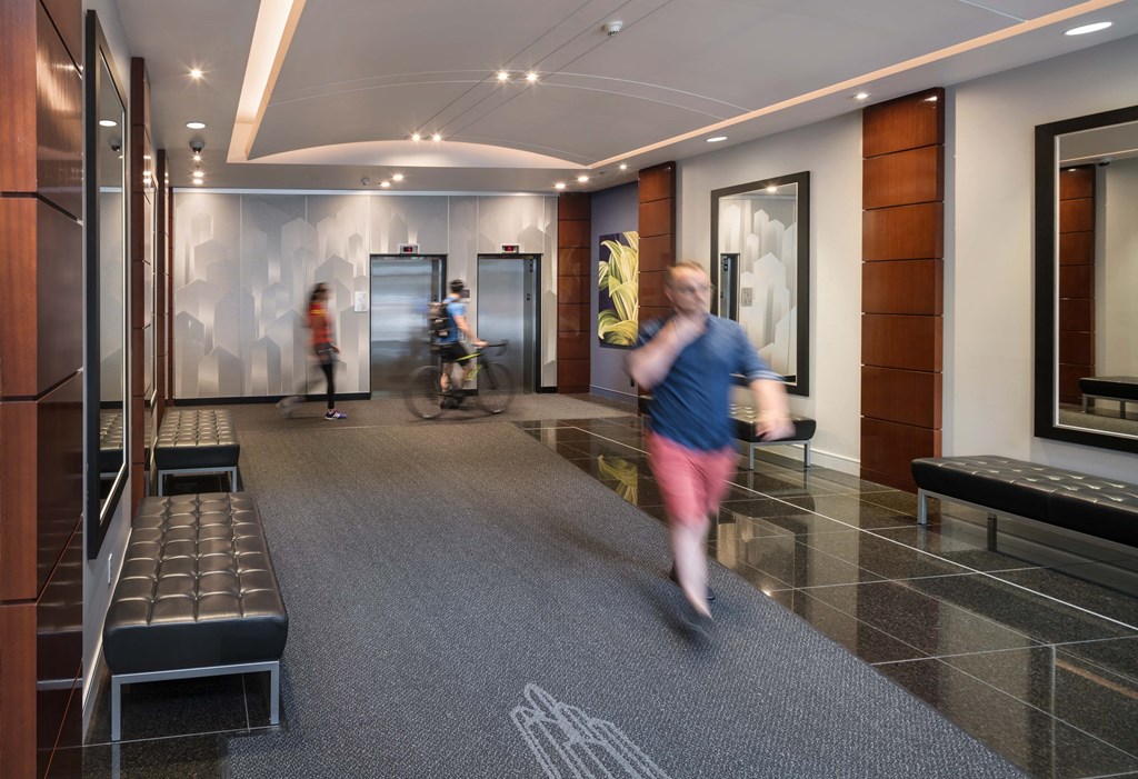 a man walking through the lobby of a building