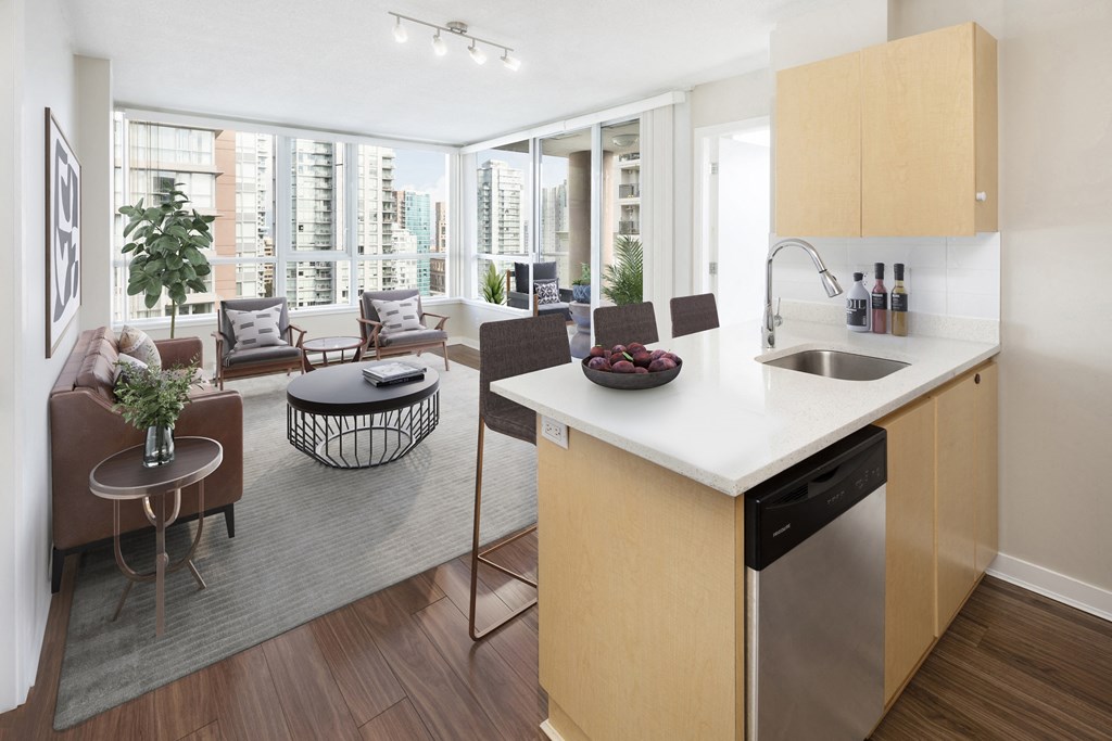 a kitchen and living room with a table and chairs and a couch