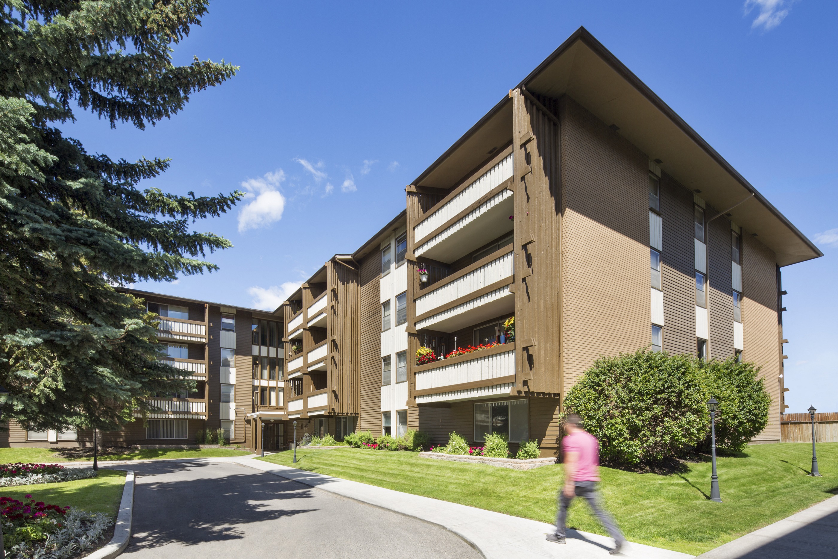 exterior picture of Lakeview Mews and a person walking