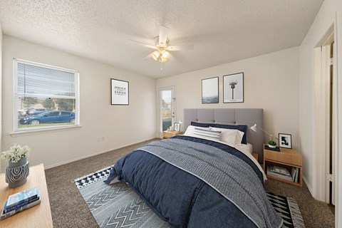 a bedroom with a large bed and a ceiling fan