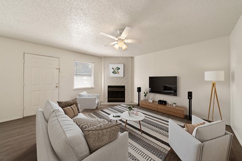 an open living room with a white couch and a tv