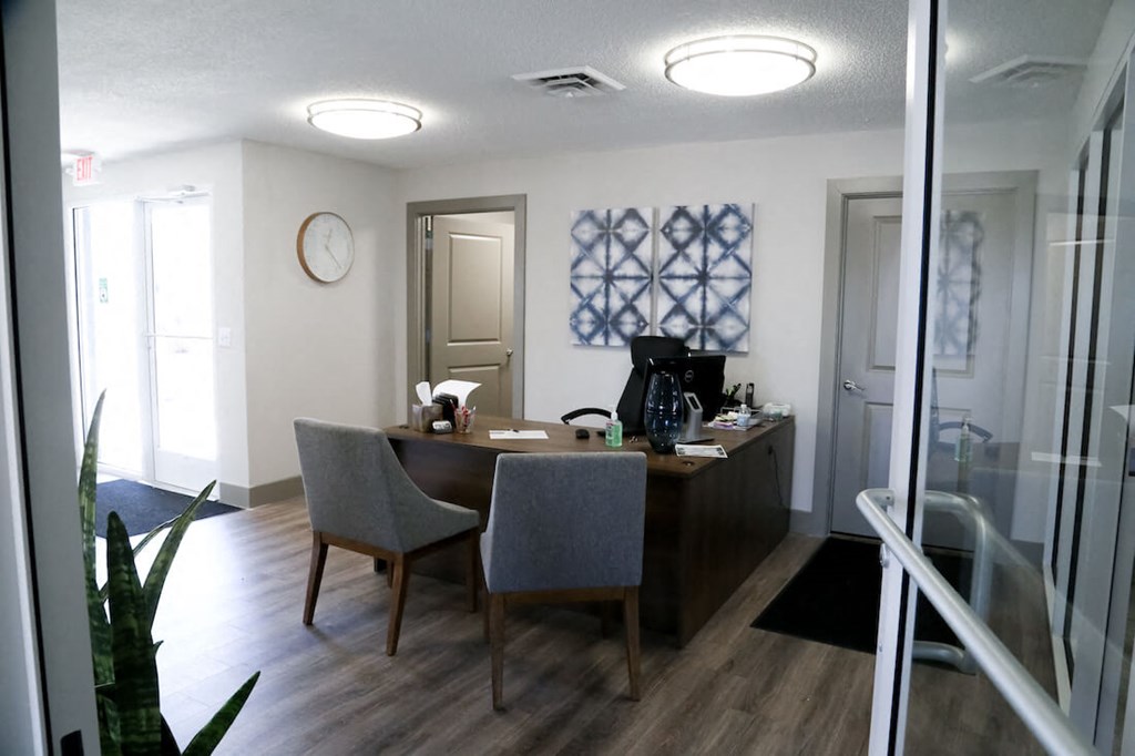 a view of a dining room with a desk and chairs