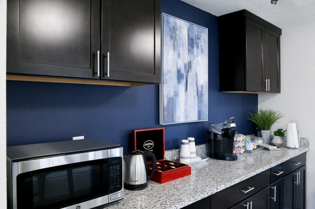 a kitchen with a counter top and a microwave