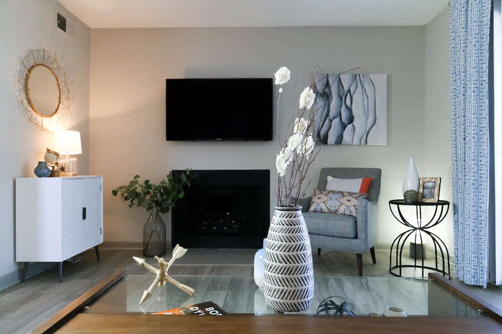 a living room with a fireplace and a tv on the wall