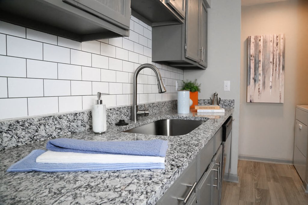 a kitchen with granite counter tops and a sink