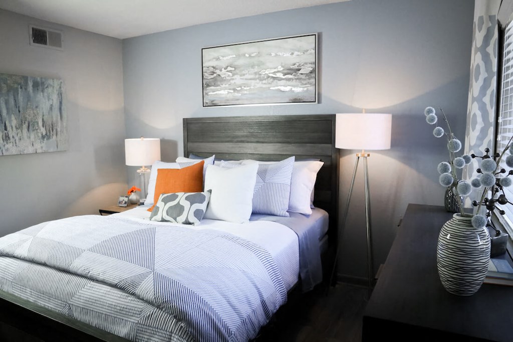 a bedroom with a bed and two lamps