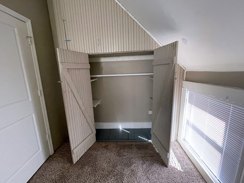 the closet in the master bedroom has two closets and a window