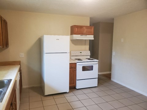 A kitchen with a white refrigerator and a white oven.
