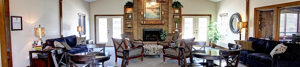 a living room filled with furniture and a large fireplace