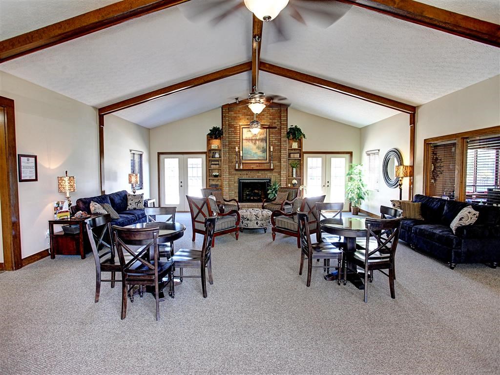 a living room with a table and chairs and a fireplace