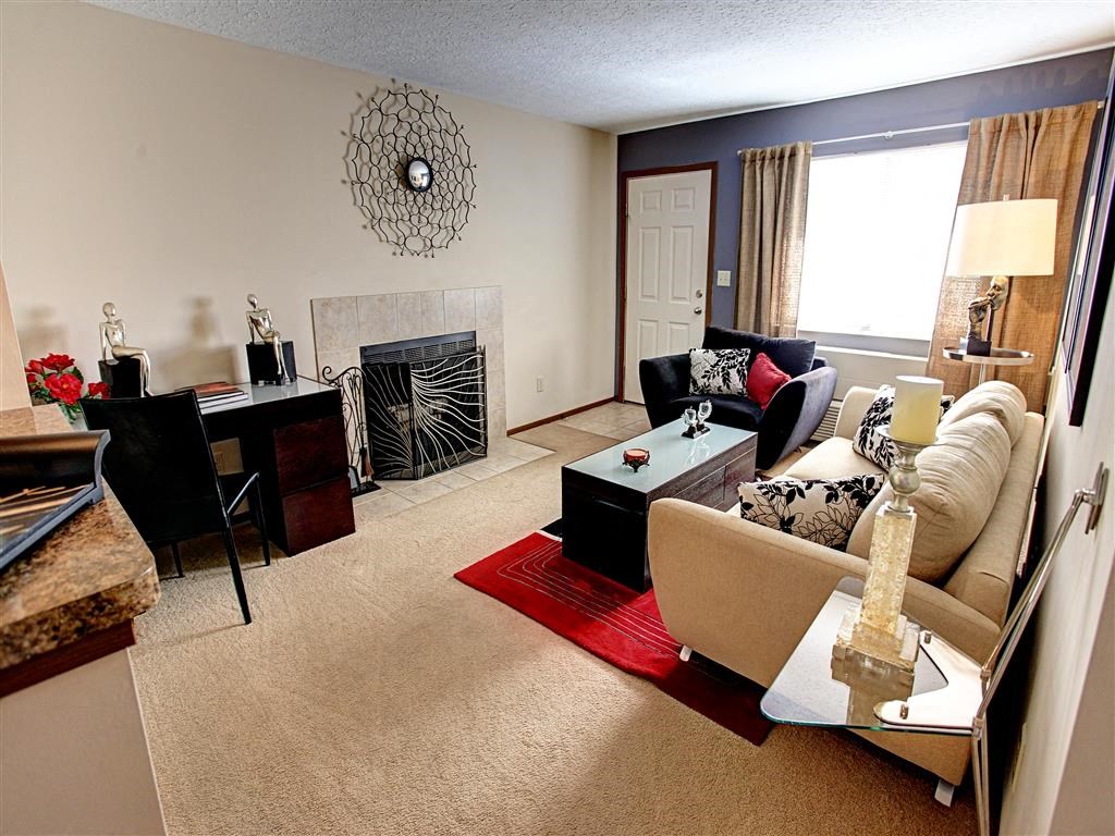 a living room filled with furniture and a fireplace