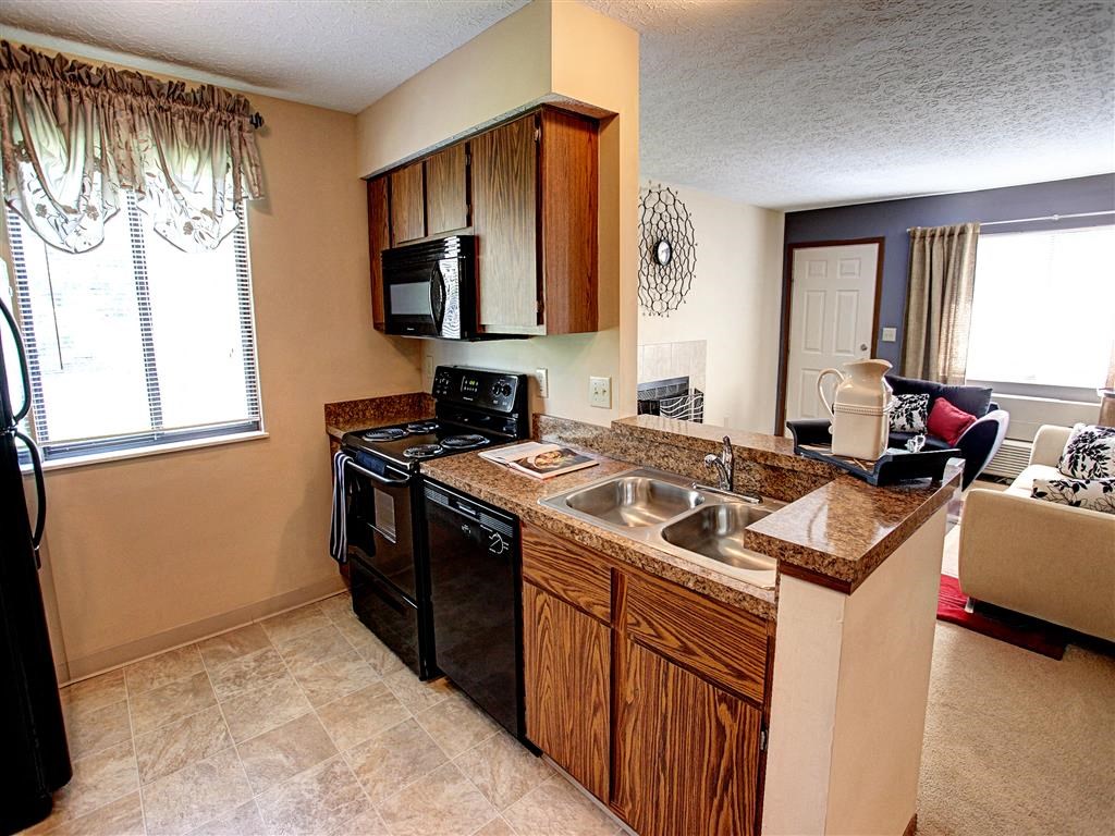 a kitchen with a sink and a stove and a microwave