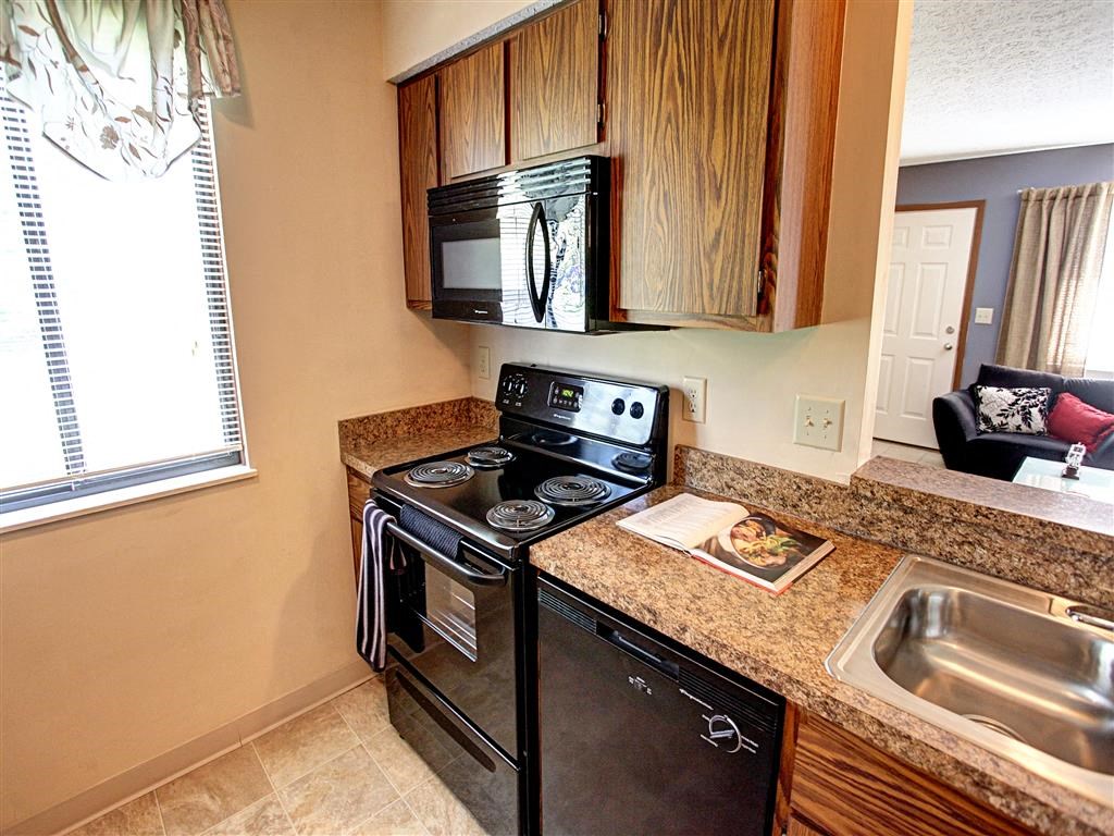 a kitchen with a stove microwave and a sink