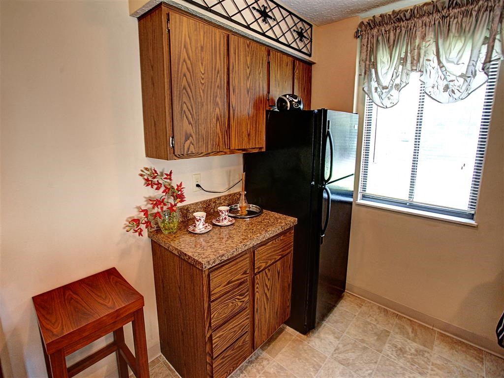a small kitchen with a refrigerator and a table