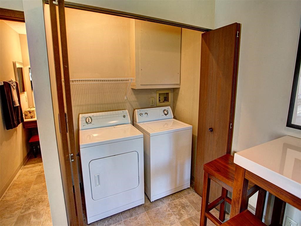 a laundry room with two washes and a dryer in it