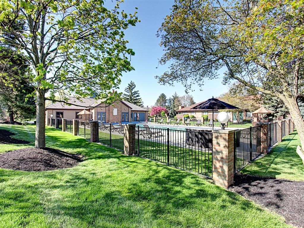 a fenced in backyard with a pool and a fence
