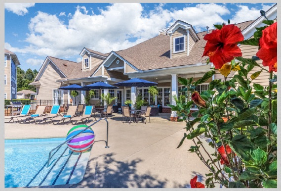 a house with a swimming pool and a deck with lounge chairs