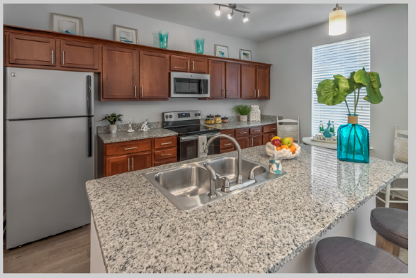a kitchen with granite counter tops and stainless steel appliances