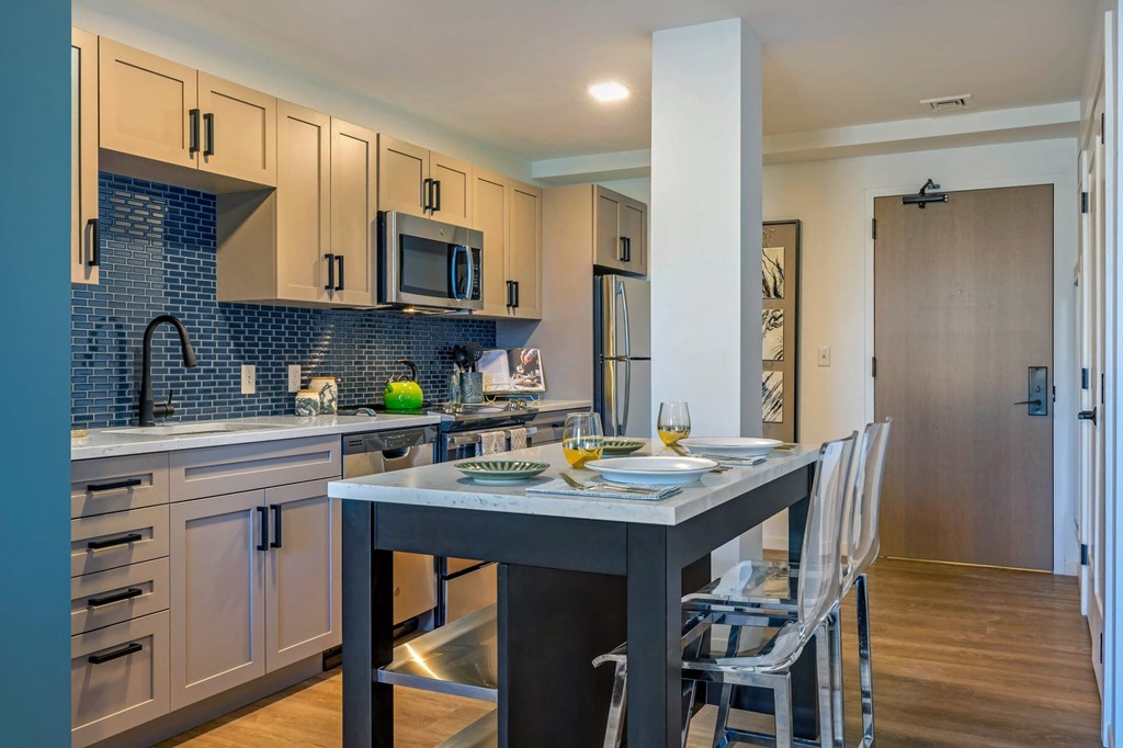 a kitchen with an island and a table with chairs