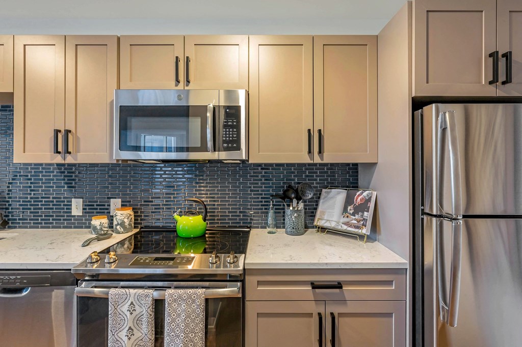 a kitchen with stainless steel appliances and white cabinets