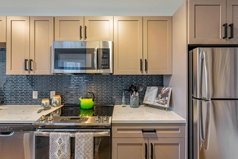 a kitchen with stainless steel appliances and white cabinets