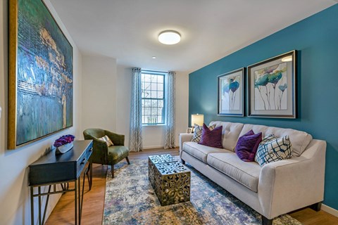 a living room with blue walls and a white couch