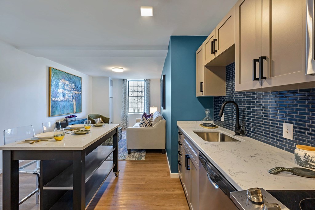 a kitchen and living room with a sink and a counter top