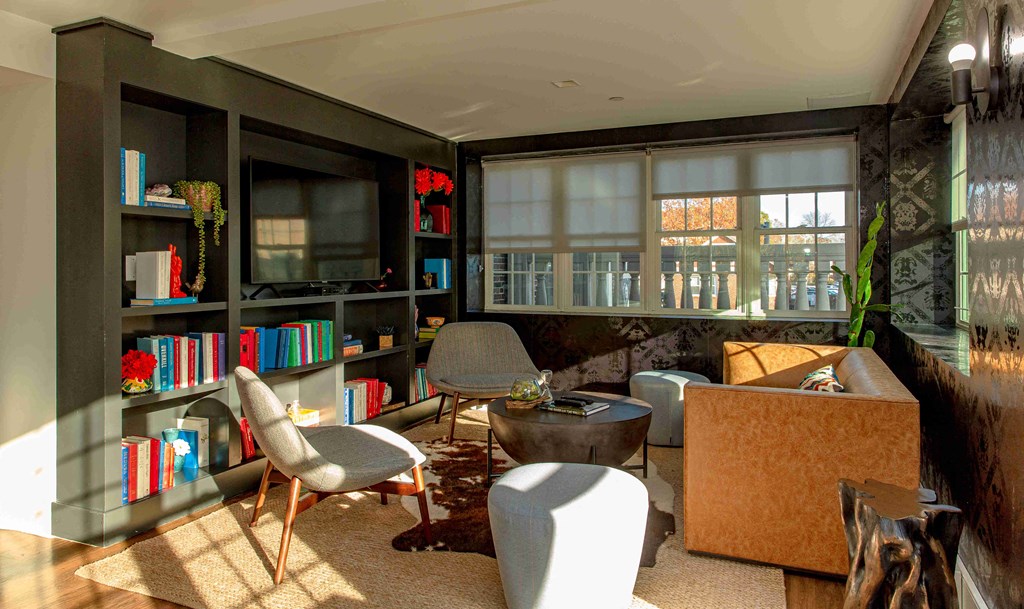 a living room filled with furniture and a large window