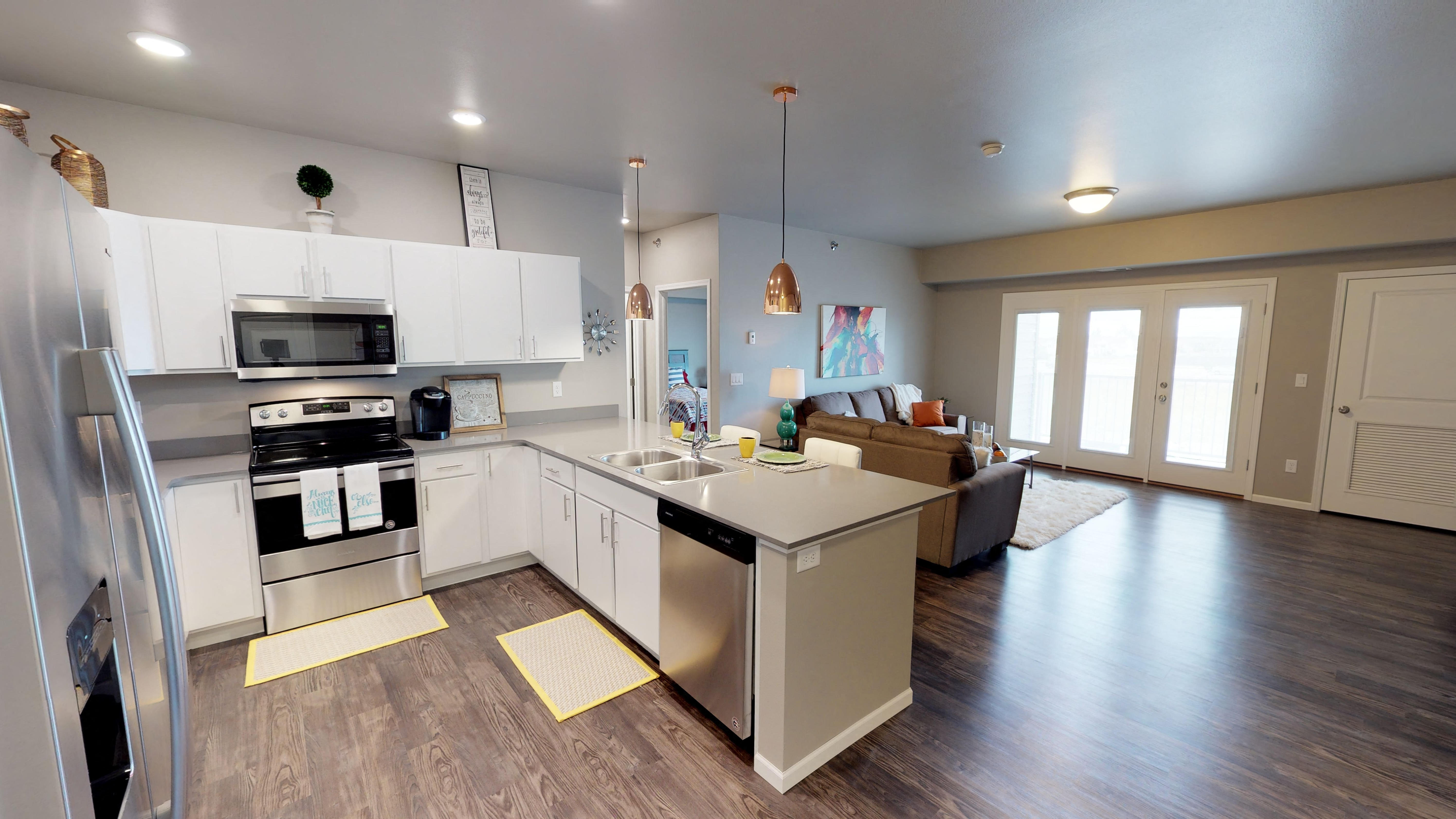 apartment kitchen, copper light fixtures, white cabinets, fargo apartments