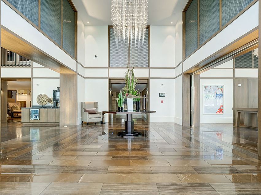 a lobby with a table and a chandelier