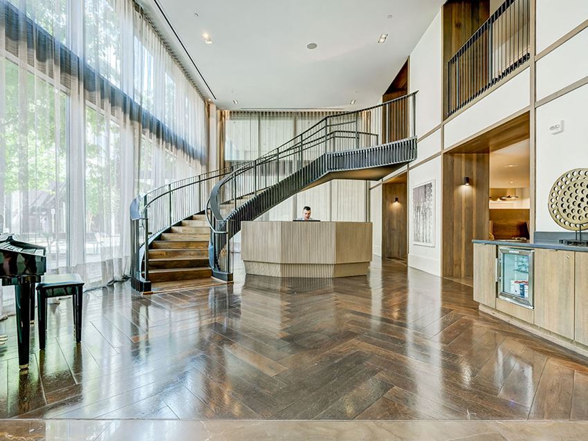 the lobby of a building with a staircase and a reception desk