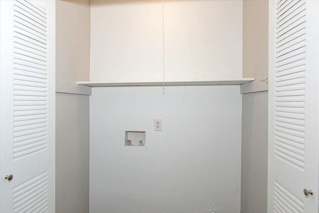an empty room with white walls and white cabinets