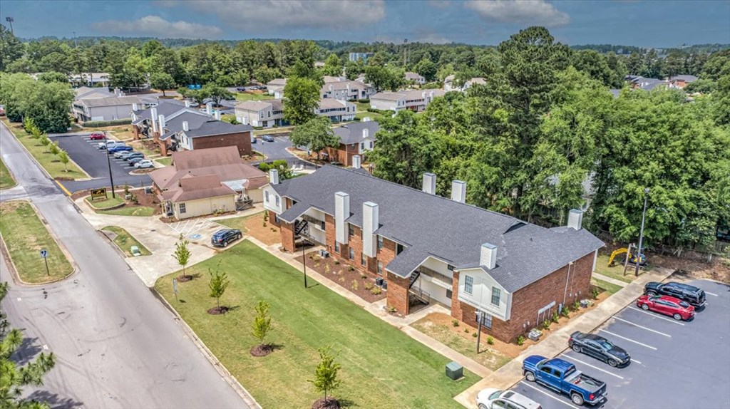 an aerial view of a neighborhood with houses and a parking lot