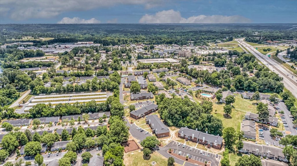 an aerial view of a city with houses and trees