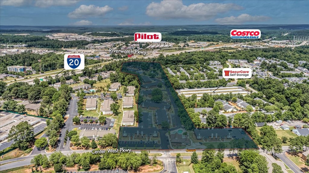 an aerial view of a city with buildings and trees and signs