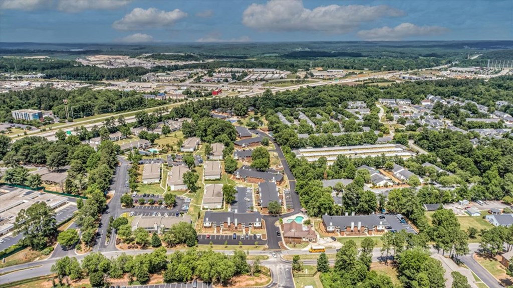 an aerial view of a city with houses and trees