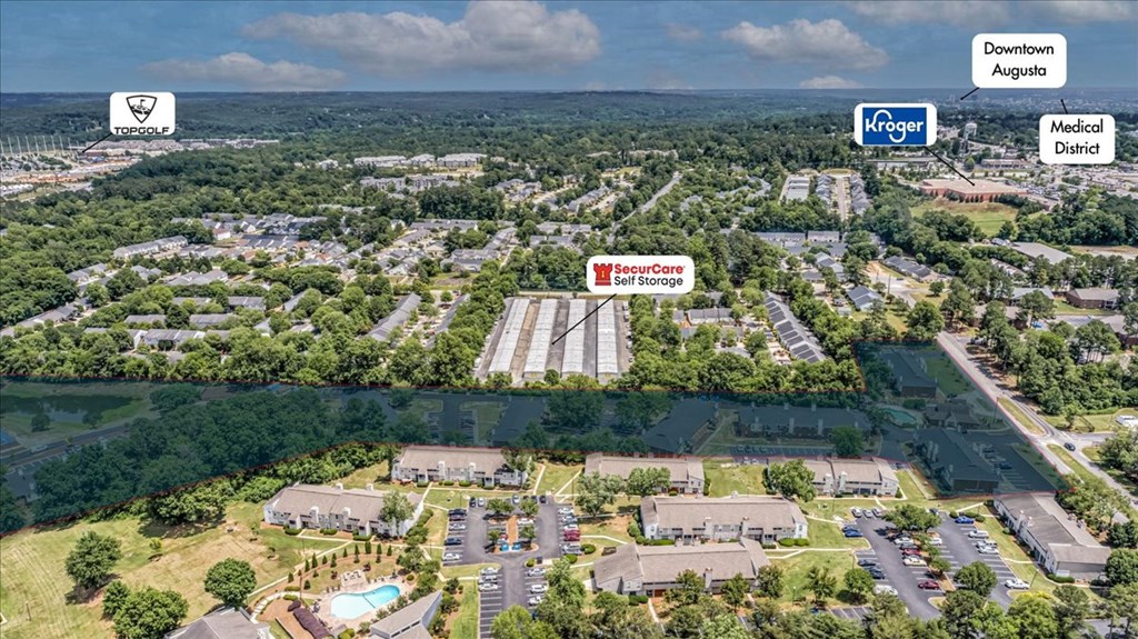 an aerial view of a neighborhood of houses and trees and a sign on a building